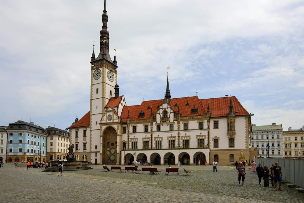 Charming view of the Old Town Hall in Olomouc, Czech Republic, with a lively urban square.